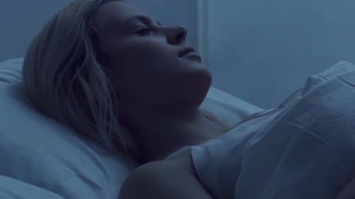 Woman Sleeping Peacefully in Bed at Night
