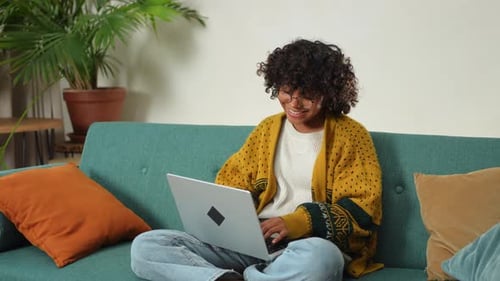 African American Girl Using Laptop at Home Office Looking at Screen Typing Chatting Reading Writing