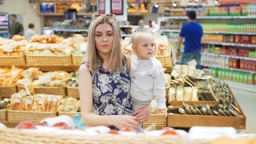 Woman and Child Shopping for Food in Supermarket
