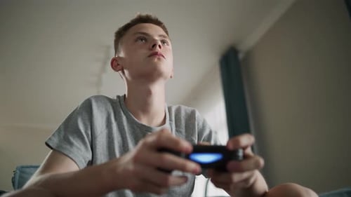 Teenager Playing Video Games at Home