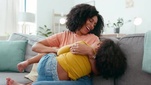 Loving Mother and Child Laughing on Couch