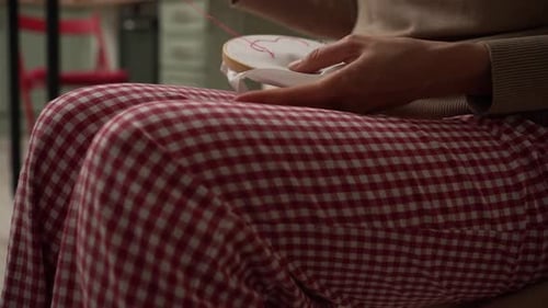 Woman Embroidering White Cloth at Home Close Up