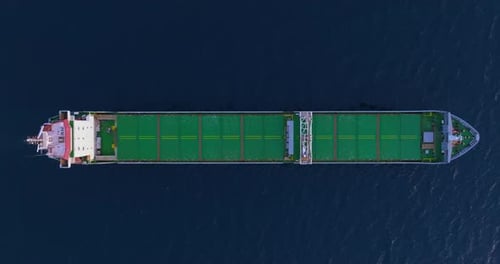Top Down Aerial View Green Large General Cargo Ship Anchored at Sea