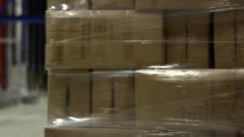 Automated Guided Vehicles Transporting Pallets In A Modern Warehouse.