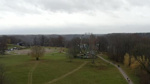 Drone flight above ferris wheel revealing a valley and stunning scenery