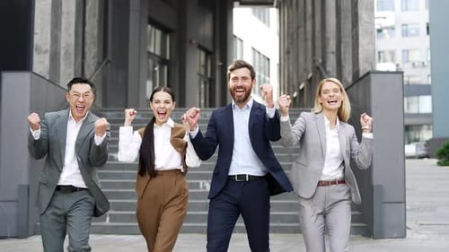 Enthusiastic Team Celebrates Success Outside Office Building