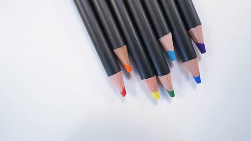 Vibrant Arrangement of Colored Pencils on a White Surface