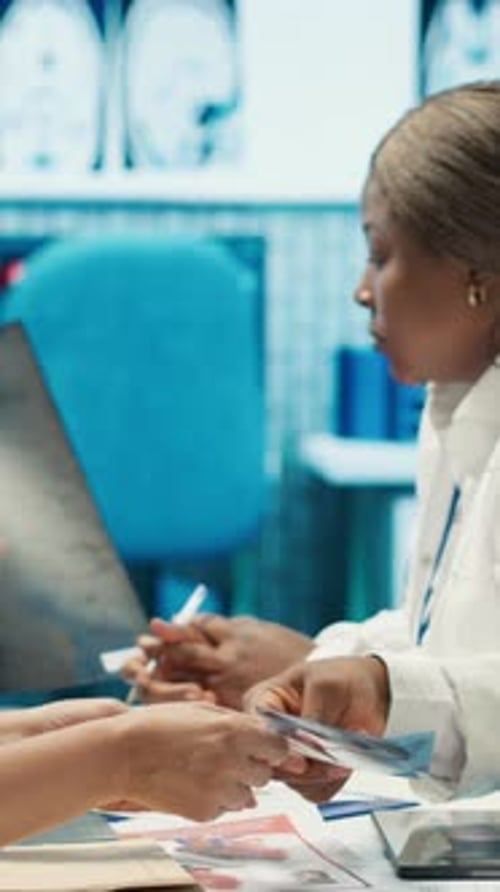 Medical Staff Reviewing X-Ray in Bright Office