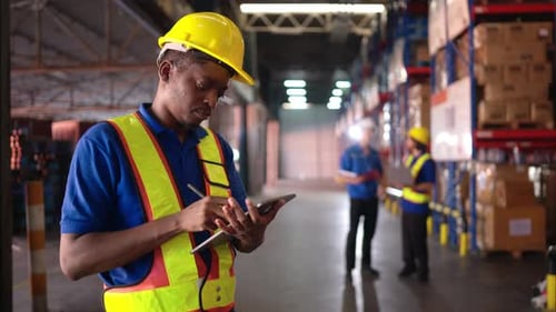 Portrait of warehouse workers are reviewing the list of items based on the documentation
