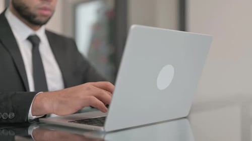 Close up of Businessman Typing on Laptop