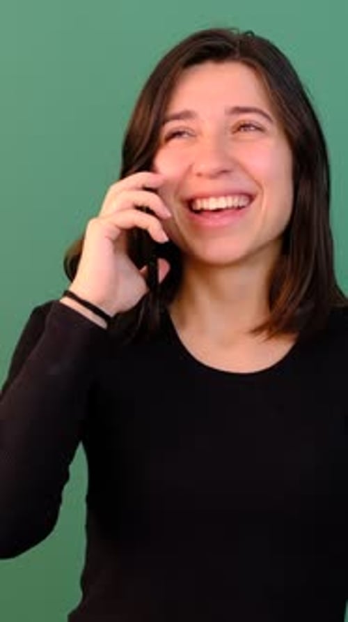 Woman Laughing and Talking on a Cell Phone