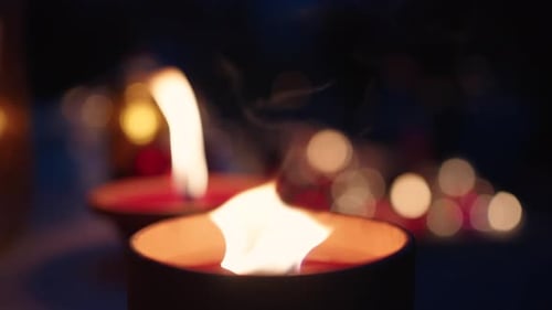 Grave Candles Lights Glowing on Cemetery at Night on All Saints Day