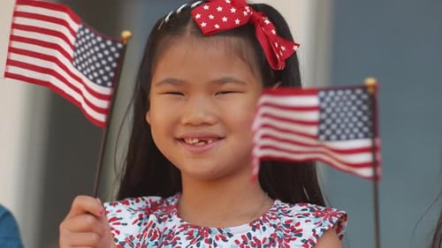 Smiling Girls Holding American Flags for Holiday
