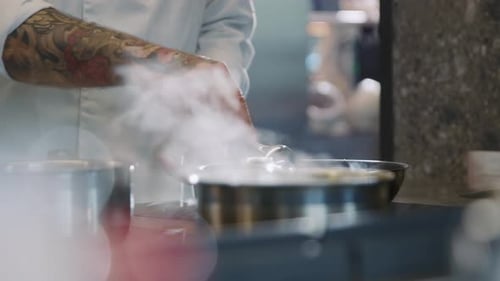 Close Up of Chef Cooking Cauliflower in Pan Vegatables Steamed Food Tattooed Hands of Man at