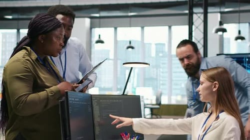 Diverse Team Collaborates on Code in Modern Office