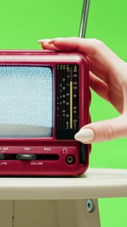 Hand Tuning Static on Retro Red Television