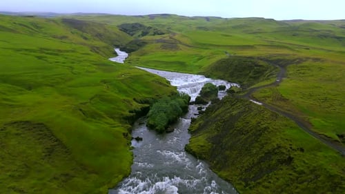 Aerial View of River and Cascading Waterfall