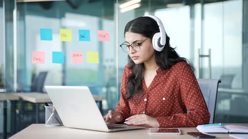 Woman Working On Laptop at Modern Office Desk
