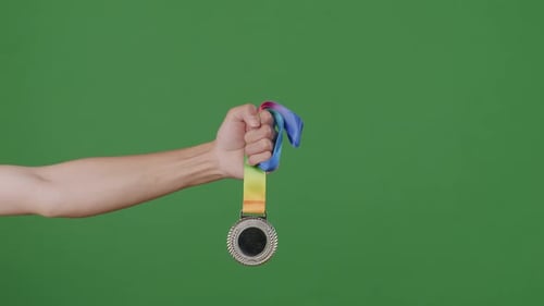 Silver Medal In Hand. Green Screen Background