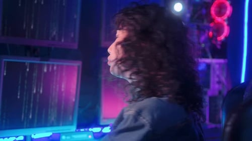 an asian woman programmer is working in her computer room