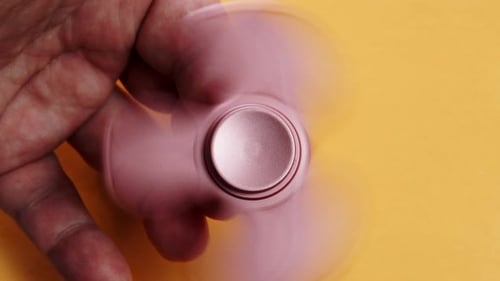 Fidget Spinner Rotating On Human Hand