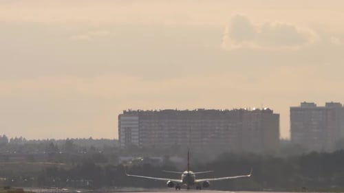 Airplane Accelerates Down Airport Runway to Take Off