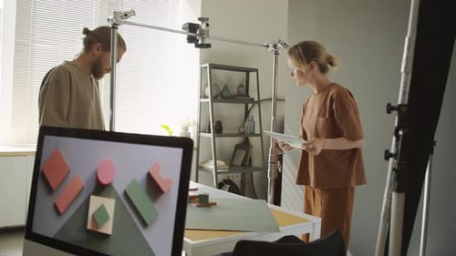 Male and Female Photographers Preparing Flatlay Composition for Shooting