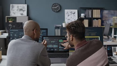 Indian Male Developers Analyzing Data Dashboard on Laptop Screen in Office