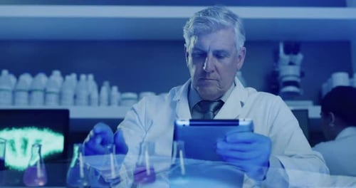 Man in Lab Coat Using Tablet With Beakers