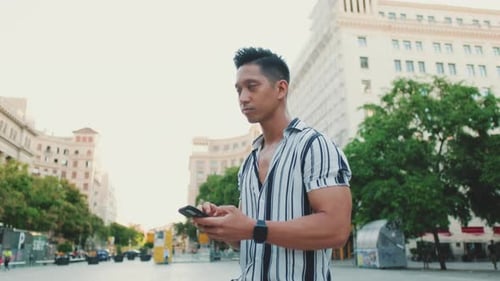 Young Adult Using Phone in City