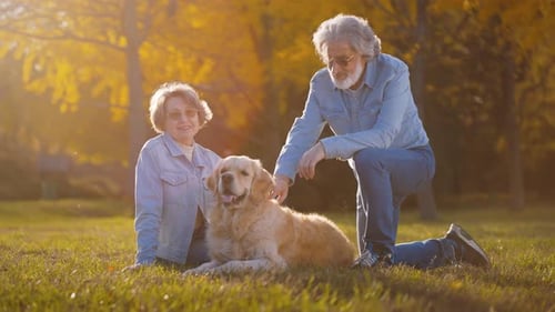 Senior Family with Dog in Park During Autumn Sunny Weather