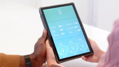 Couple Using Smart Home App on Tablet