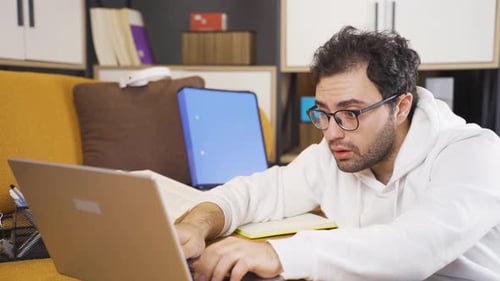 Young Adult with Laptop Reacts Negatively to Screen