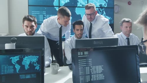 Team IT Security Professional Working in Bright Monitoring Room Filled with Displays