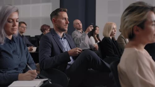 Diverse Group Attending Corporate Presentation Taking Notes