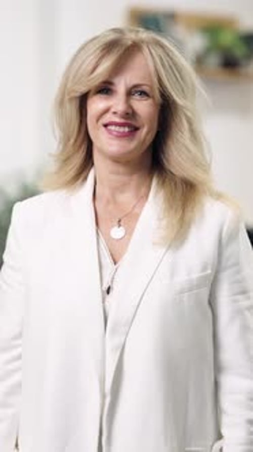Confident Mature Businesswoman Crossing Her Arms and Smiling Vertical