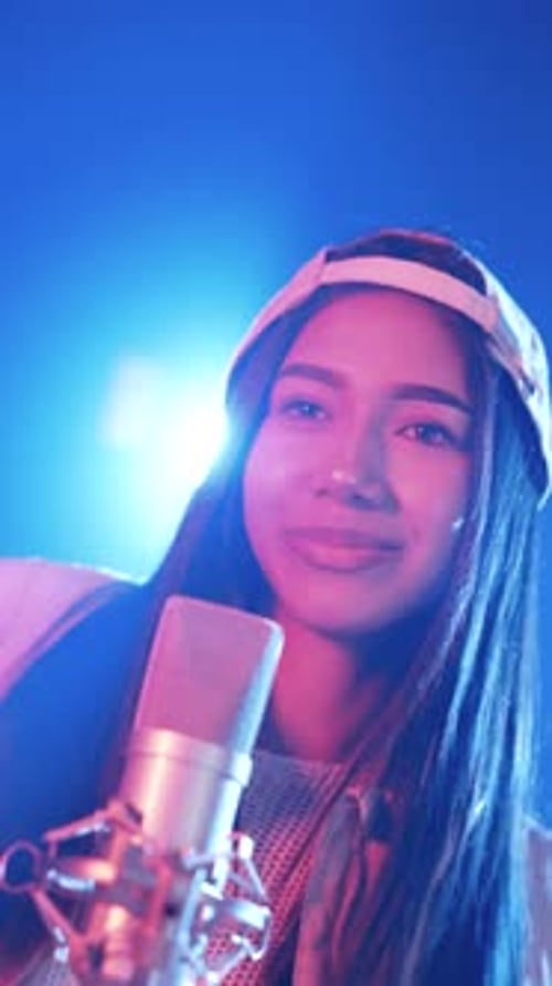 Young Asian Pop Singer Rapping Into a Studio Microphone Vertical