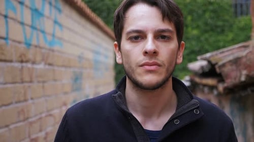 Man Walking in Urban Alleyway With Graffiti
