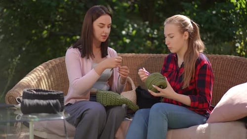 Women Crochet Together on a Sunny Afternoon