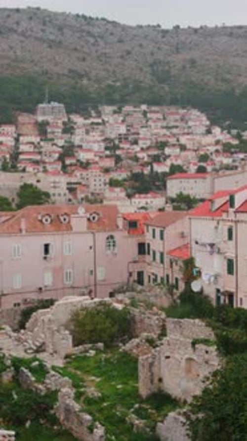 Ancient Stone Remains Overlook Picturesque Terraced Area Calm Overcast Day Highlights Historic Ruins