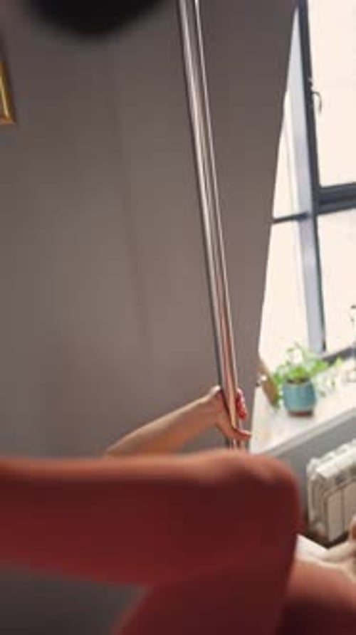 Woman Doing Exercise Upside Down Inverted Position on Balanced Body Cadillac Machine at Studio