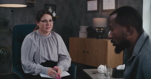 Man Talking to Therapist in Modern Office