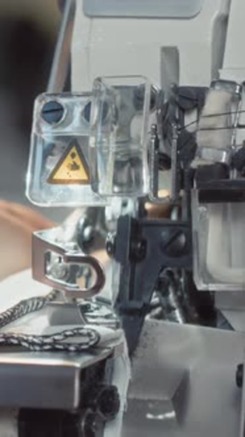 Vertical of Sewing Machine Making Seams and Cutting Cloth