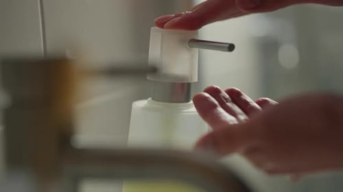 Washing Hands with Liquid Soap in Bathroom