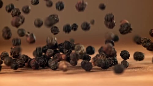 Black Pepper Falls on a Wooden Table Filmed on a Highspeed Camera at 1000 Fps