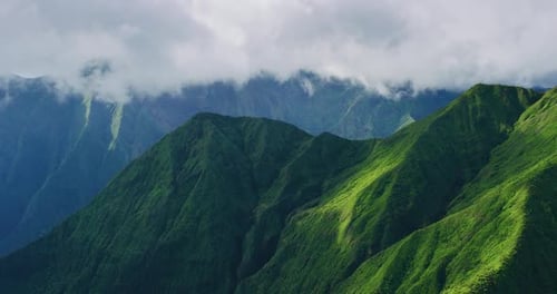 Misty Clouds Roll Over Bright Green, Dramatic Tropical Mountain Ridges