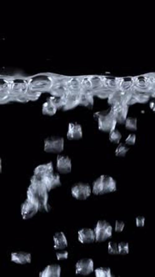Bubbles Rising Through Clear Liquid on Black