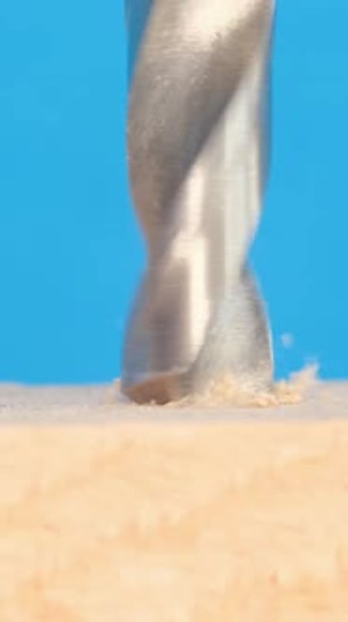 Drill Bit Drilling Hole in Wood Close Up
