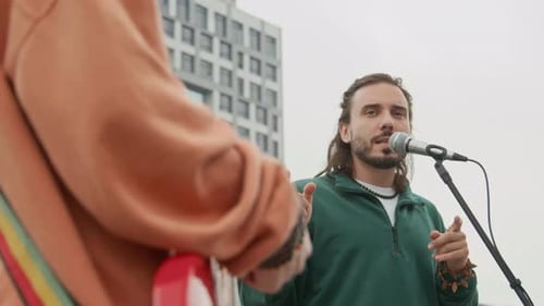 Young Male Rock Band Vocalist Singing while Performing in City Street