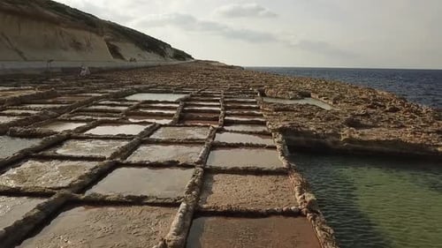 Aerial view of the salt pans at Xwejni bay, Gozo, Malta. Dolly shot of the salt pans, with the ocean